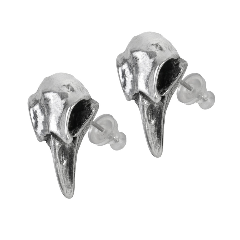 Close-up of gothic raven skull stud earrings crafted in fine pewter with realistic detail.