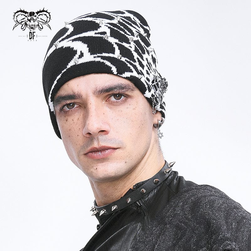 Model wearing Arachnid beanie, emphasizing the white spiderweb design and edgy silver rivets against the black knit fabric.