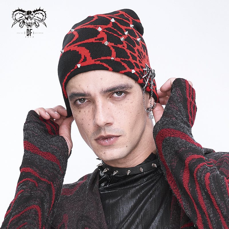 Model wearing Arachnid beanie with bold red spiderweb design, silver spikes, and gothic styling.