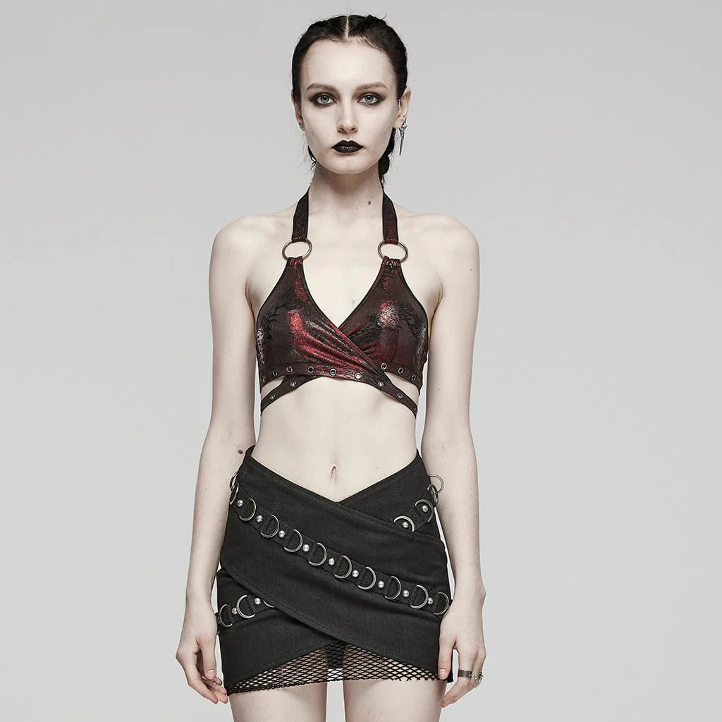 Model wearing the Red Bellied gothic women's cropped bralette, showcasing the wrap-up halterneck style with eyelet detailing and a bold O-ring accent. The red and black metallic sheen and abstract pattern create a striking, edgy look.